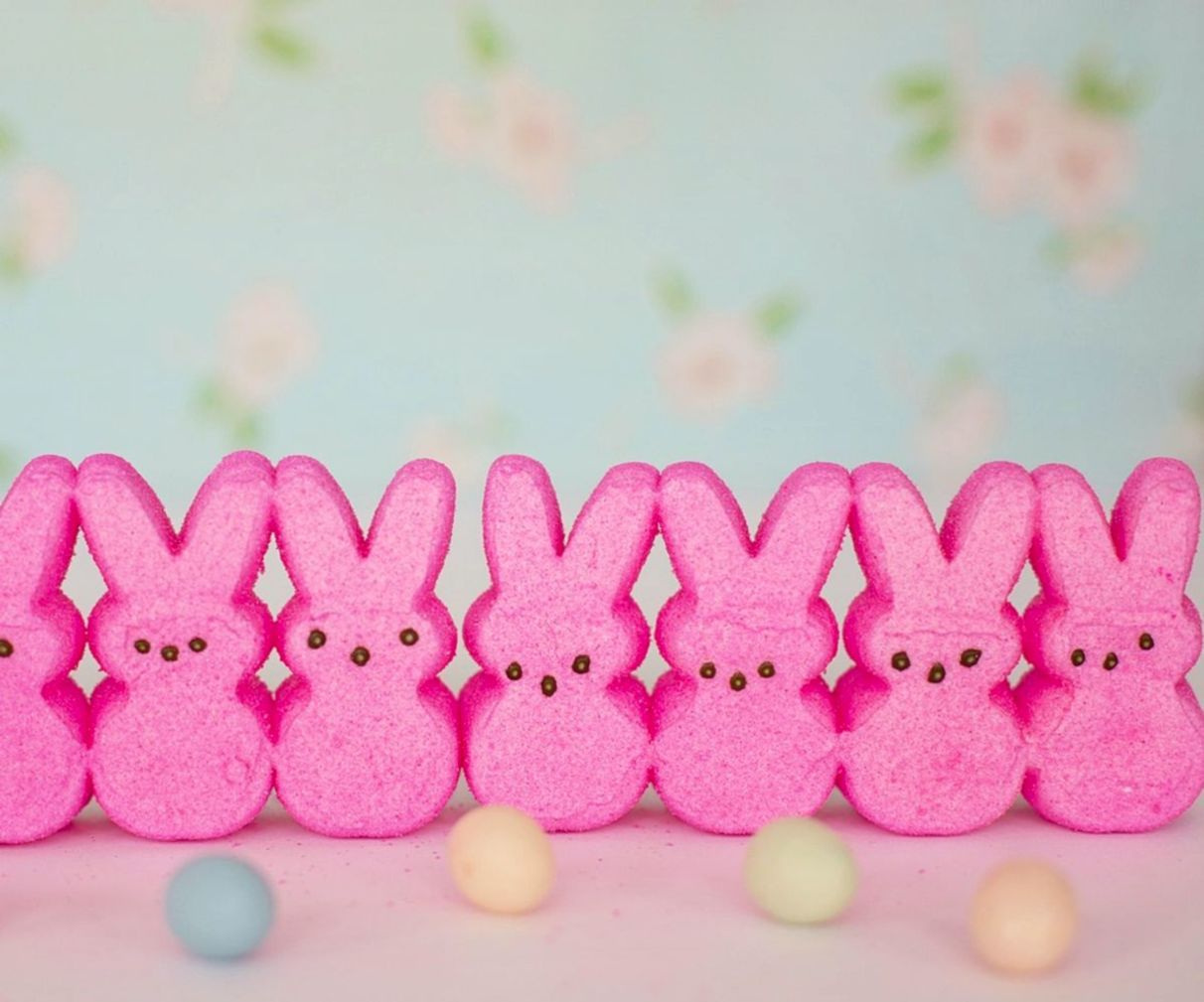 Hands crafting chocolate moulds filled with premium confectionery
